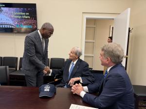 Congressman Gregory Meeks and Congressman Michael McCaul visit with Judge William Webster before receiving their copies of "Character Matters". They are at a table in Congressman McCaul