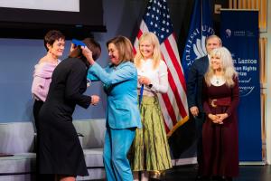 Speaker of the House Emerita Nancy Pelosi places the Lantos Prize medal around Sviatlana Tsikhanouskaya's neck