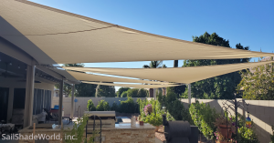 Several custom shade sails from Sail Shade World in a backyard