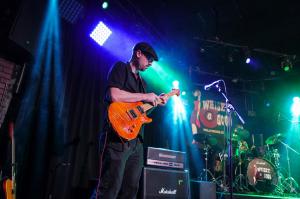 David Lazar of TWOFEW commands the stage at Whisky A Go Go, driving the band's powerful sound with his intense performance.