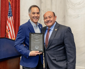 photo of two men holding award