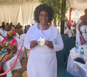 Md. Tabitha Mogonchi, DHL, Chief Principal Kereri Girls High School, showcases her Presidential Heroes Award, which recognizes her as a heroine in the category of National Cohesion.  Photo: Tabitha Mogonchi.