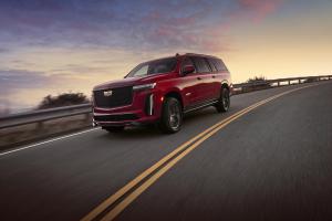 An image of a red Cadillac Escalade V-Series on a highway