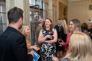 Guests engaging in cocktails and conversations during at the Tyler Mansion