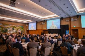 Participants watch U.S. Army Gen. Christopher Cavoli, Supreme Allied Commander Europe, share insights on strengthening international defense partnerships.