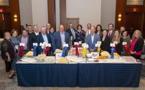 Members of the Prairie Farms board of directors, leadership team, and NMPF leaders pose with winning cheeses at the NMPF Dairy Product Judging Contest