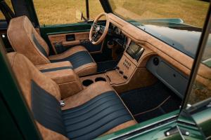 Interior view of the 1977 Ford Bronco built by Kincer Chassis, showcasing custom seats, dashboard, and modernized vehicle controls.