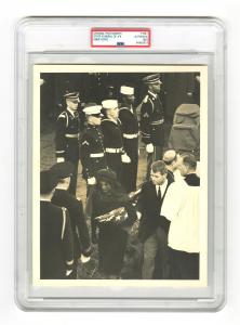 Lot #133 is a Type 1, PSA-encapsulated 8 inch by 10 inch original photograph of President Kennedy’s State Funeral, taken by Abbie Rowe, in near-fine condition (est. $450-$750).