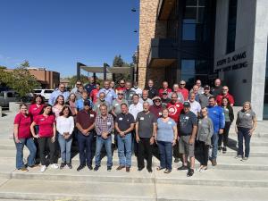 A photo of a group of people standing in front of a municipality building.