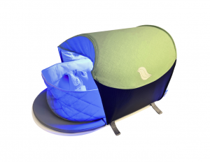 newborn being treated in bili-hut portable phototherapy device