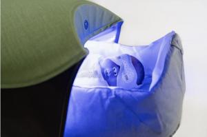 closeup of newborn treated in bili-hut phototherapy device