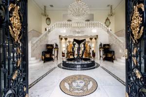 Elegant two-story marble entry hall with fountain and grand staircase