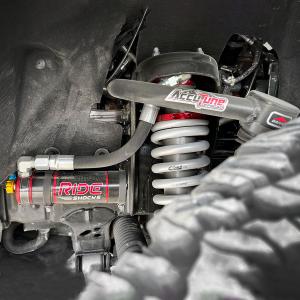 Close-up of AccuTune Offroad Upper Control Arm and Ride Shocks installed on a Ford Bronco, showcasing premium suspension upgrades designed for enhanced offroad durability and tire clearance.