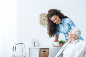 Always Family caregiver assisting a man with his coffee