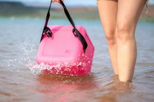 Woman holding FOAM cooler at the lake.