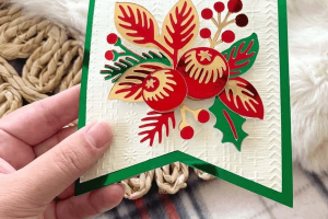 A handmade Christmas card crafted from 12x12 cardstock with intricate scrapbook paper details, perfect for festive greetings.