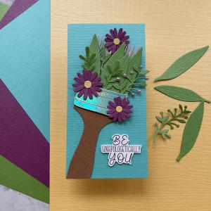 A premium 12x12 cardstock in a lush fern green, featuring a smooth, slightly shimmering finish perfect for high-quality crafts and design projects.