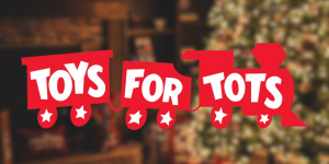 Toys fot Tots logo in front of a holiday background