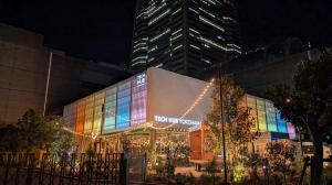 Colorfully-lit exterior of Tech Hub Yokohama, a stylish tech and innovation center with beautiful lights and natural outdoor space