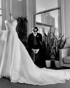 Guillermo Pharis at his studio with a wedding gown