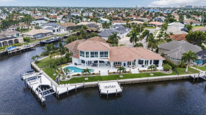 This boater's dream home features a new (2023) remote-controlled docking system, featuring a large boat lift accommodating a 34 ft. boat (16,000 pounds), a smaller lift for a 22 ft. boat (5,000 pounds) and a double waverunner automatic lift platform that 