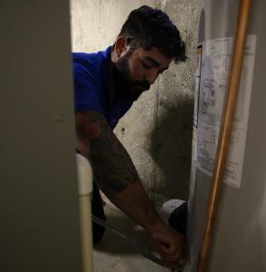 J. Blanton Plumbing technician conducting water heater maintenance, emphasizing the importance of regular upkeep and the company’s expertise in water heater repair and plumbing contractor services.