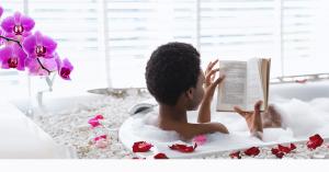 Lady in a luxurious bathtub reading