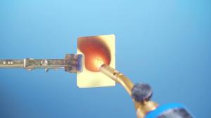 A blowtorch is applied to a tile of a new 'dream material' aerogel that withstands the extreme temperature of the flame.