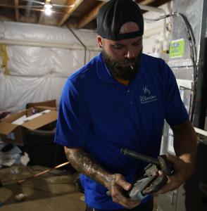 J. Blanton Plumbing technician performing a residential water heater installation, highlighting the company’s expertise in plumbing contractors and water heater services for the Naperville Park District's Santa's Workshop 2024.