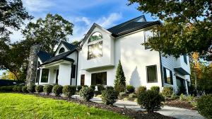 Side view of the house after the renovation with white stucco in the front