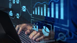 Hand typing on keyboard with data related graphics and scientific charts overlaid