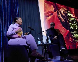 Woman on stage giving a lecture.