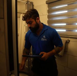 J. Blanton Plumbing technician conducts an emergency plumbing repair, showcasing the company’s expertise in frozen pipe repair, plumbing maintenance, and emergency plumbing services for winter preparedness in Chicagoland homes.