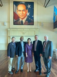 Excelsior University Board of Trustees chair emeritus Don Dea, Lt. Gen. Arthur Gregg, Excelsior Board of Trustees member Rose Wang, Excelsior president David Schejbal, and Excelsior Board of Trustees treasurer A.D. Kent Clark (left to right) pose under a 