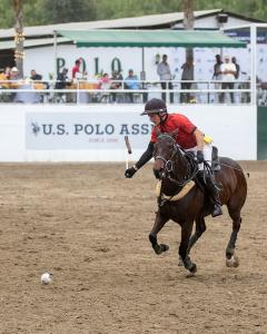 an arena polo player hits a ball in the air during the 2023 US Open Arena Polo Championship