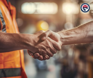 The image shows a contractor and homeowner joining hands, symbolizing trust, teamwork, and a shared commitment to building better homes and stronger communities.