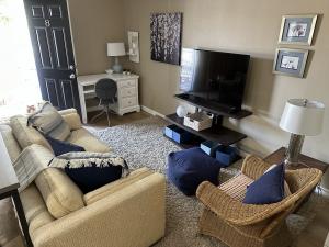 A renovated living room with modern furniture, fresh paint, and cozy décor, creating a warm and inviting space for families at Thomas House Family Shelter.