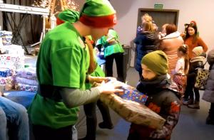 A gift being delivered by an icreatives team member dressed as an elf to Ukrainian refugee children in Poland.