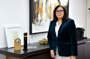 Ms. Mouna Lebnioury, CEO of Bank Al Yousr with Global Brand Frontier Award Trophy