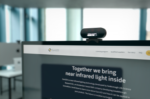 Image shows SunBooster, the Near-Infrared device by SunLED Life Sciences attached to computer screen