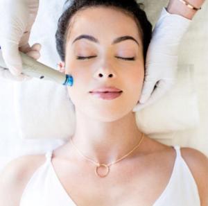 Image of a woman receiving a facial treatment.