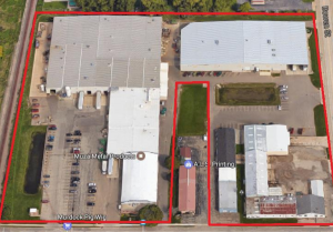 Overhead aerial photograph of 606 East Murdock Avenue industrial facility in Oshkosh, showing multiple buildings with white roofs, parking areas, and loading docks outlined in red to indicate property boundaries