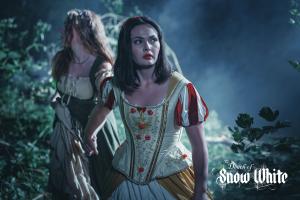 Snow White leads her friend, Yvonne through the forest at night