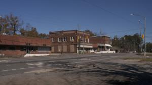 Store front in Pine Hill, Alabama alongside an empty road