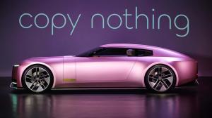 A sleek, futuristic Jaguar electric vehicle in a metallic pink finish, displayed in a minimalistic setting with the tagline "Copy nothing" in bold, elegant lettering above. The car's design features sharp, modern lines and innovative wheel details, reflec