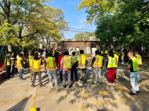 A group of students in hi-vis gear look on to an instructor.