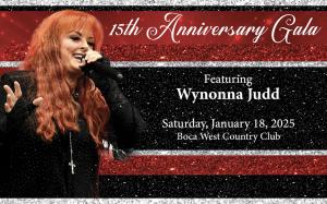 Wynonna Judd performing with her guitar