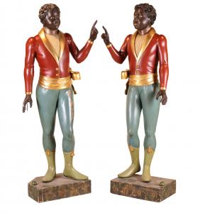 Extraordinary pair of mid-19th century carved wooden figures depicting enslaved men dressed as liveried footmen, meticulously crafted by unknown artisans. Estimate: $15,000-$25,000.