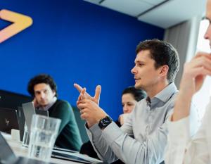 Four members of the Wattstor team sit around a boardroom table, discussing Price Protect