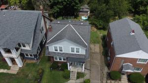 Liberty Roofing Pro’s team conducting a winter roof inspection on a home in Erie, Pennsylvania, ensuring it’s ready for heavy snowfall.